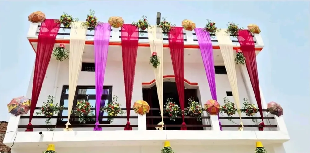 Wedding house exterior decoration with colourful drapes, flowers and umbrellas in Patna